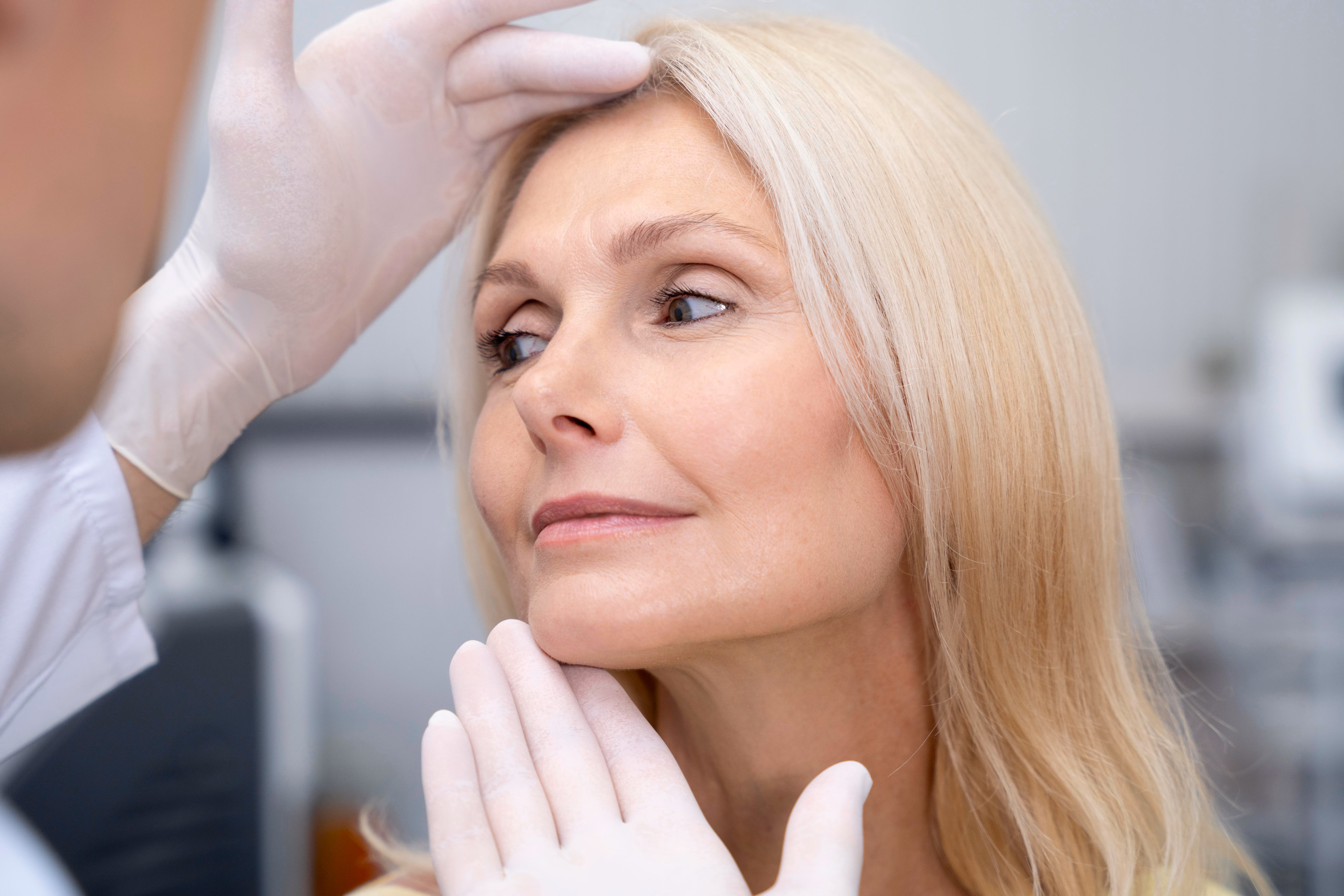 A doctor carefully assessing a patient's skin